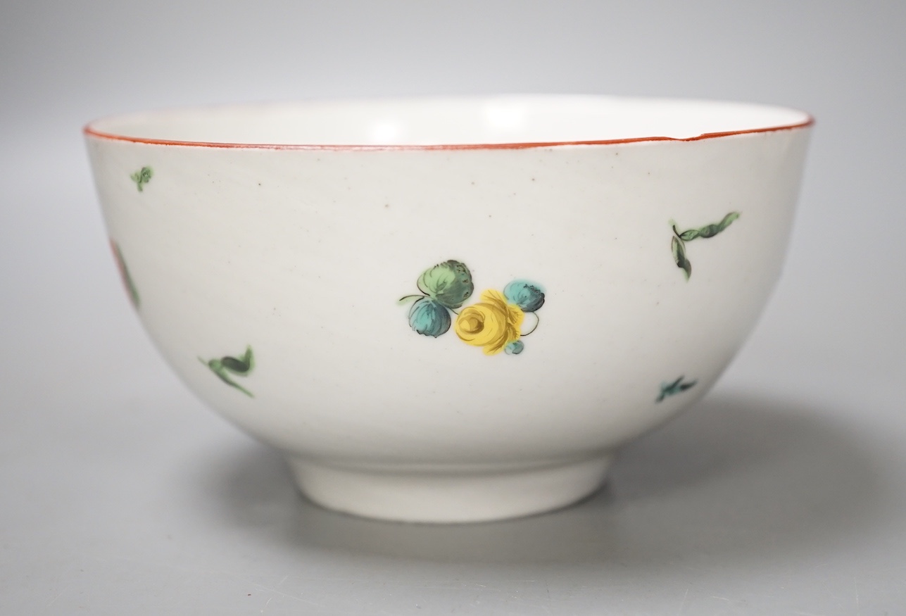 A Bristol porcelain bowl painted with a spray of flowers and scattered sprigs, crossed swords dot mark in under-glaze blue c.1775
